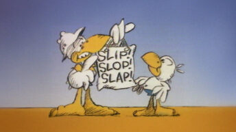 Slip Slop Slap still image from the Australian sun safety campaign showing two cartoon seagulls, one taller seagull leaning in with an arm around a hanging sign that reads Slip Slop Slap, and a smaller seagull standing to the right, with a sandy ground and blue sky behind them