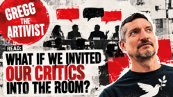 peace movement critics: Red, black and white distressed editorial artwork for Gregg the Artivist. Gregg appears on the right wearing a black T-shirt with a white peace dove carrying an olive branch. Behind him, four silhouetted people sit at a panel discussion facing press cameras, with red and black speech bubbles above them. A large red Gregg the Artivist logo appears at the upper left. Bold text across the image reads: “READ: What If We Invited Our Critics Into the Room?”