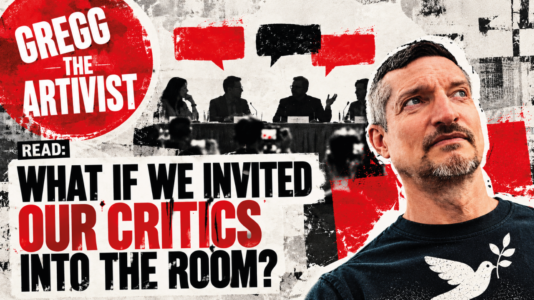 peace movement critics: Red, black and white distressed editorial artwork for Gregg the Artivist. Gregg appears on the right wearing a black T-shirt with a white peace dove carrying an olive branch. Behind him, four silhouetted people sit at a panel discussion facing press cameras, with red and black speech bubbles above them. A large red Gregg the Artivist logo appears at the upper left. Bold text across the image reads: “READ: What If We Invited Our Critics Into the Room?”